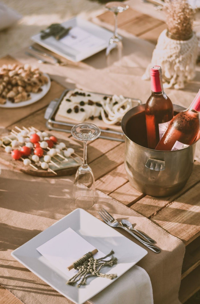 wine and food on a set table, featured in Villa Pereire’s blog on how to host an apero, a French happy hour